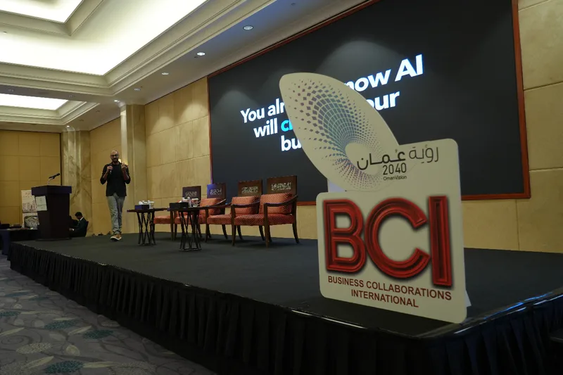 Akram Ahmed presenting Orfloat’s AI work beside BCI and Oman Vision 2040 event signage
